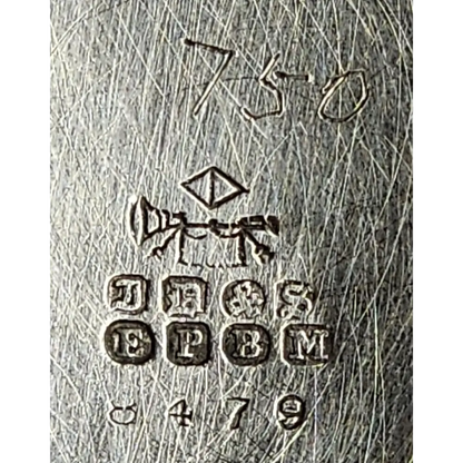 Close-up of a metal surface with engraved text and symbols
