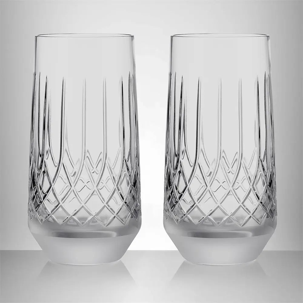 Two clear cut-crystal highball glasses with vertical and diamond-patterned engravings, shown side-by-side on a reflective light gray surface against a neutral gray background from our Waterford Crystal Australia – Outlet & Sale Collection