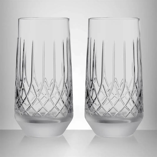 Two clear cut-crystal highball glasses with vertical and diamond-patterned engravings, shown side-by-side on a reflective light gray surface against a neutral gray background from our Waterford Crystal Australia – Outlet & Sale Collection