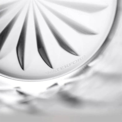 Close-up of a clear glass water feature or fountain basin with a faceted circular design and the brand name WATERFOR1 subtly etched near the rim.
