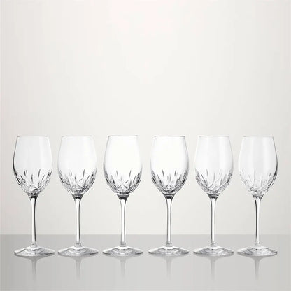 Six clear cut-crystal wine glasses arranged in a row on a light gray reflective surface against a light gray background from our Waterford Crystal Australia collection 